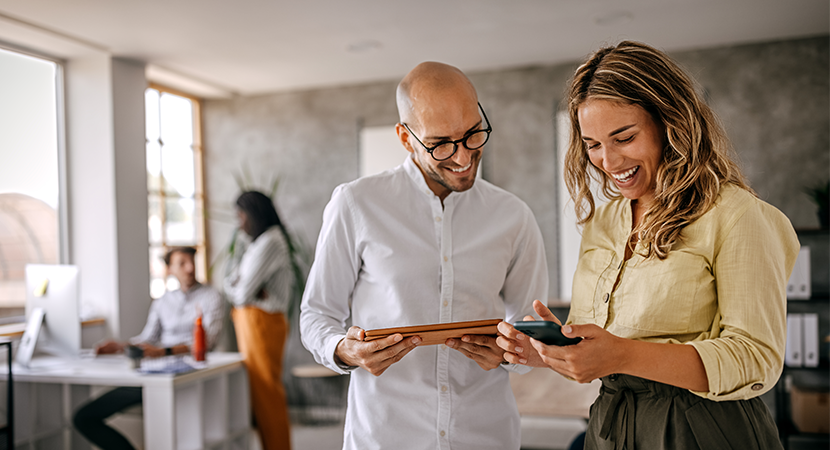 two people reviewing information on mobile device
