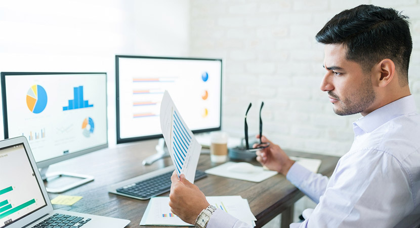 Man at computer looking at graphs