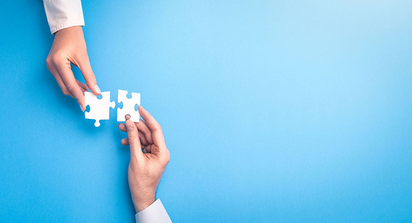 People holds in hand a jigsaw puzzle.