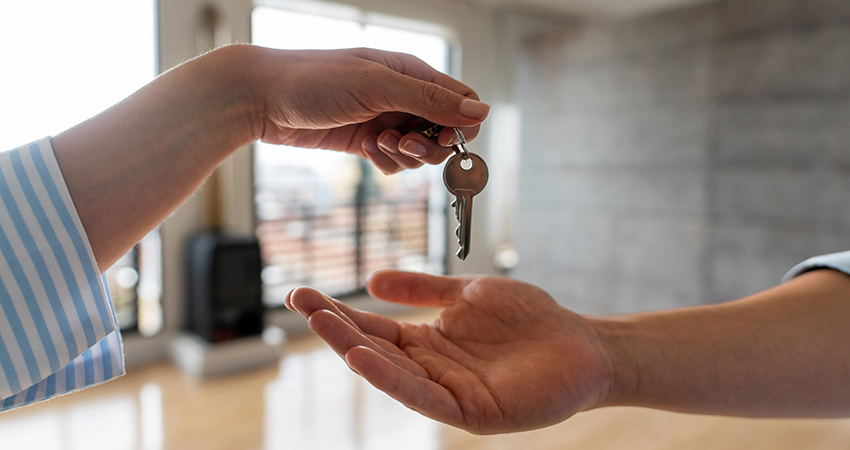 Person turning over unit key to next tenant